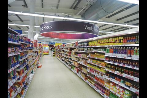 An outsize ‘World Foods’ beacon is at odds with the loud yellow, blue and red signage